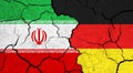 Flags of Iran and Germany on cracked surface