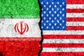 Flags Of Iran And USA Painted On Cracked Wall Background/Iran Versus USA Conflict Concept