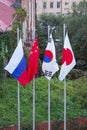 Flags of Japan, Russia, China, Republic of Korea on the flagpoles