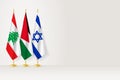 Flags of Lebanon, Jordan and Israel stand in row on indoor flagpole