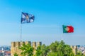 Flags of Lisbon and portugal waving over the saint george castle Royalty Free Stock Photo