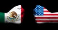 Flags of Mexico and United States painted on two clenched fists facing each other on black background/Mexico - USA relations conce Royalty Free Stock Photo