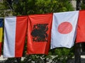 The flags of Monaco, Albania and Japan