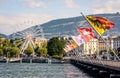 Flags on the Mont Blanc bridge and ferris wheel in Geneva Royalty Free Stock Photo