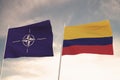 Flags of NATO and COLOMBIA waving with cloudy blue sky background,3D rendering WAR