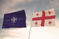 Flags of NATO and GEORGIA waving with cloudy blue sky background,3D rendering WAR