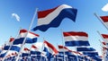 Flags of Netherlands waving in the wind against blue sky. Royalty Free Stock Photo