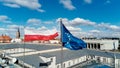 Waving polisg flag and european union flag on building Royalty Free Stock Photo