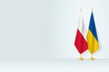 Flags of Poland and Ukraine on flag stand, meeting between two countries