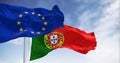 flags of Portugal waving with European Union flag on a clear day