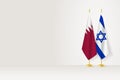 Flags of Qatar and Israel on flag stand, meeting between two countries Royalty Free Stock Photo