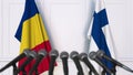 Flags of Romania and Finland at international meeting or negotiations press conference. 3D rendering Royalty Free Stock Photo