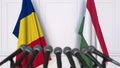Flags of Romania and Hungary at international meeting or negotiations press conference. 3D rendering Royalty Free Stock Photo