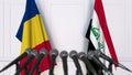 Flags of Romania and Iraq at international meeting or negotiations press conference. 3D rendering Royalty Free Stock Photo