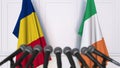 Flags of Romania and Ireland at international meeting or negotiations press conference. 3D rendering Royalty Free Stock Photo