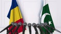 Flags of Romania and Pakistan at international meeting or negotiations press conference. 3D rendering Royalty Free Stock Photo