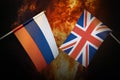 Flags of Russia and great britain against background of a fiery explosion. The concept of enmity and war between Royalty Free Stock Photo