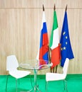 Flags of Russia, Italy, EU and table chairs