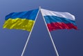 Flags of Russia and Ukraine against a blue sky. Escalation of the conflict. The concept of confrontation.