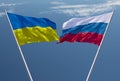 Flags of Russia and Ukraine against a dramatic cloudy sky. Escalation of the conflict. The concept of confrontation. Royalty Free Stock Photo