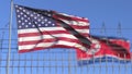 Waving flags of the USA and North Korea separated by barbed wire fence. Conflict related conceptual 3D rendering Royalty Free Stock Photo