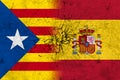 Flags of spain and catalonia on broken wall