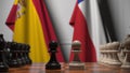 Flags of Spain and Chile behind pawns on the chessboard. Chess game or political rivalry related 3D rendering