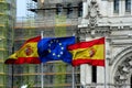 The flags of Spain and the European Union flutter in the wind creating a very institutional image