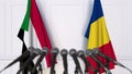 Flags of Sudan and Romania at international meeting or negotiations press conference. 3D rendering Royalty Free Stock Photo