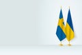 Flags of Sweden and Ukraine on flag stand, meeting between two countries