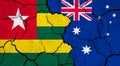 Flags of Togo and Australia on cracked surface