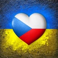 Flags of Ukraine and Czech. Flag heart on the background of the Ukrainian flag painted on a stone. The concept of protection.