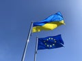 flags of Ukraine and European Union against blue sky Royalty Free Stock Photo