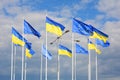 Flags of Ukraine and European Union EU against the blue sky. Royalty Free Stock Photo