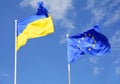 Flags of Ukraine and European Union EU against the blue sky. Royalty Free Stock Photo