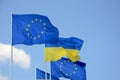 Flags of Ukraine and European Union EU against the blue sky. Royalty Free Stock Photo