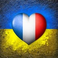 Flags of Ukraine and France. Flag heart on the background of the Ukrainian flag painted on a stone. The concept of protection.