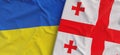 Flags of Ukraine and Georgia. Linen flags close up. Flag made of canvas. Ukrainian. Georgian. National symbols. 3d illustration Royalty Free Stock Photo