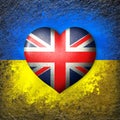 Flags of Ukraine and Great Britain.Flag heart on the background of the Ukrainian flag painted on a stone. The concept of