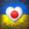 Flags of Ukraine and Japan. Flag heart on the background of the Ukrainian flag painted on a stone. The concept of protection.