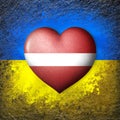 Flags of Ukraine and Latvia. Flag heart on the background of the Ukrainian flag painted on a stone. The concept of protection.