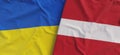 Flags of Ukraine and Latvia. Linen flags close up. Flag made of canvas. Ukrainian. Latvian, Riga. National symbols. 3d Royalty Free Stock Photo