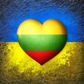 Flags of Ukraine and Lithuania. Flag heart on the background of the Ukrainian flag painted on a stone. The concept of protection.