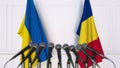 Flags of Ukraine and Romania at international meeting or negotiations press conference. 3D rendering Royalty Free Stock Photo