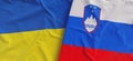 Flags of Ukraine and Slovenia. Linen flags close up. Flag made of canvas. Ukrainian. Slovenian, Ljubljana. National symbols. 3d