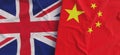 Flags of United Kingdom and China. Linen flags close-up. Flag made of canvas. Chinese. Great Britain. UK flag. State national