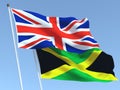The flags of United Kingdom and Jamaica on the blue sky. For news, reportage, business. 3d illustration