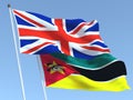 The flags of United Kingdom and Mozambique on the blue sky. For news, reportage, business. 3d illustration