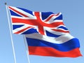 The flags of United Kingdom and Russia on the blue sky. For news, reportage, business. 3d illustration Royalty Free Stock Photo