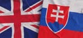Flags of United Kingdom and Slovakia. Linen flags close-up. Flag made of canvas. Bratislava Great Britain. UK flag. State national